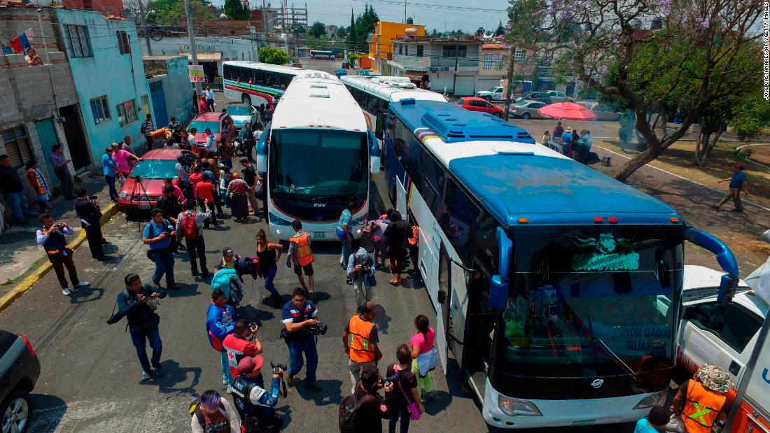 Undeterred by Trump, caravan buses arrive in border city