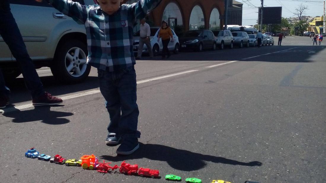 Protesters blocked roads in Armenia's capital. This little boy used his toy cars