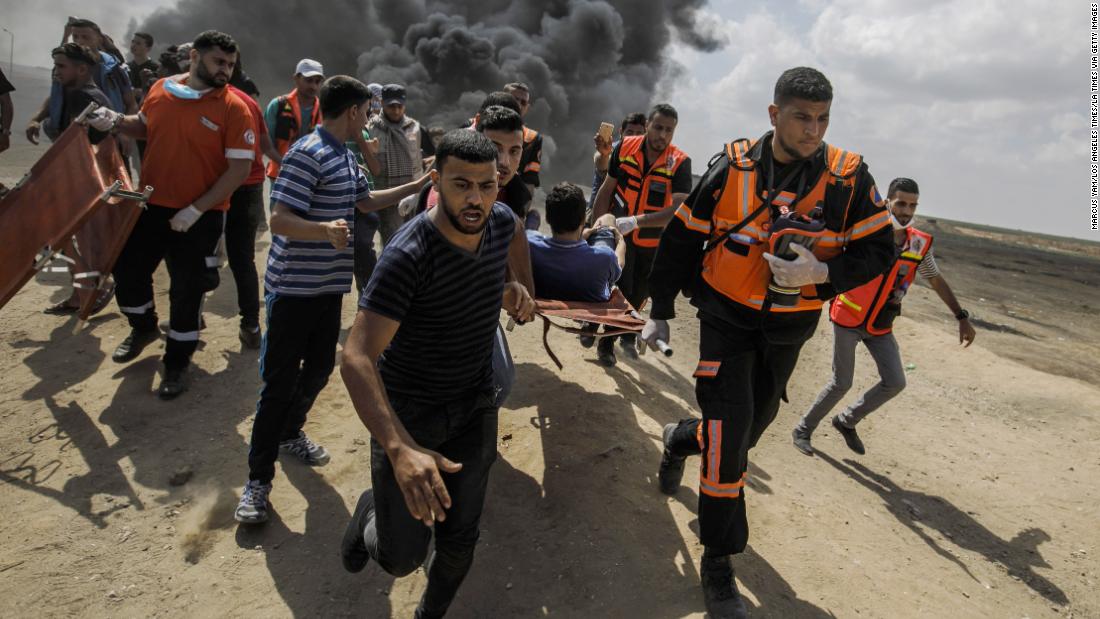 Palestinians bury their dead as Israel defends bloody Gaza crackdown